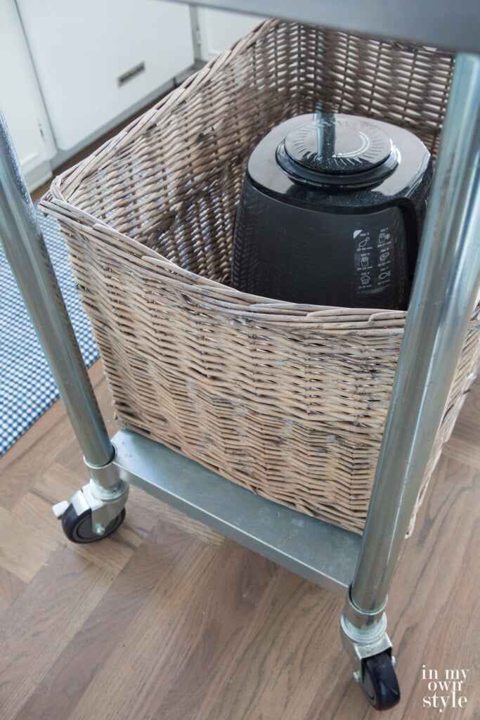 Large grey Kubu style storage basket on rolling kitchen island.