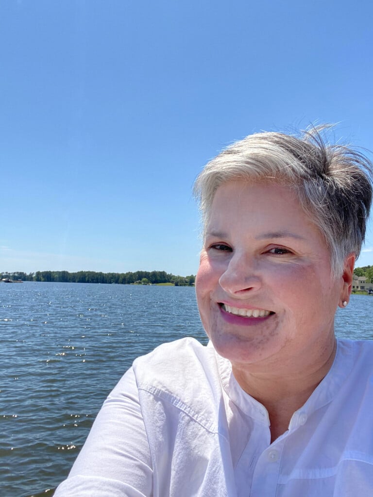 blogger In My Own Style standing on lakeside dock