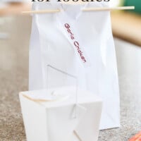 Image of a Chinese take out box and a white lunch bag with a chop stick closure on it. Gift Bag for foodies