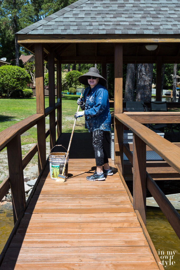 Lakefront Gazebo and dock floor being stained by Diane
