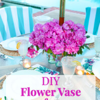Pink flowers on a patio table with an umbrella pole in the center.