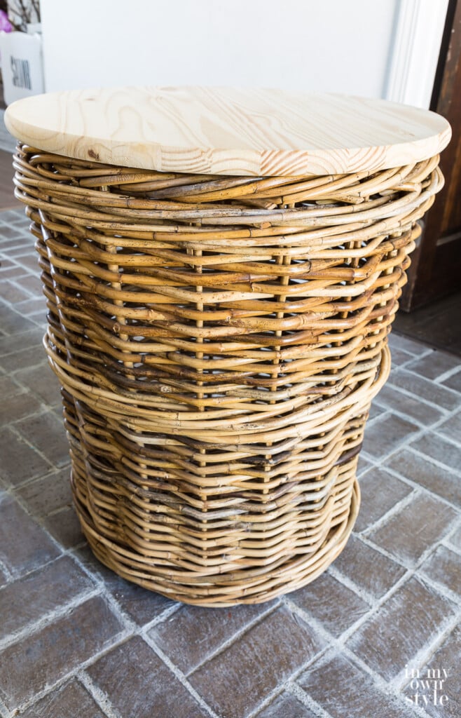 Side table idea. Wicker basket with round wood top on it.