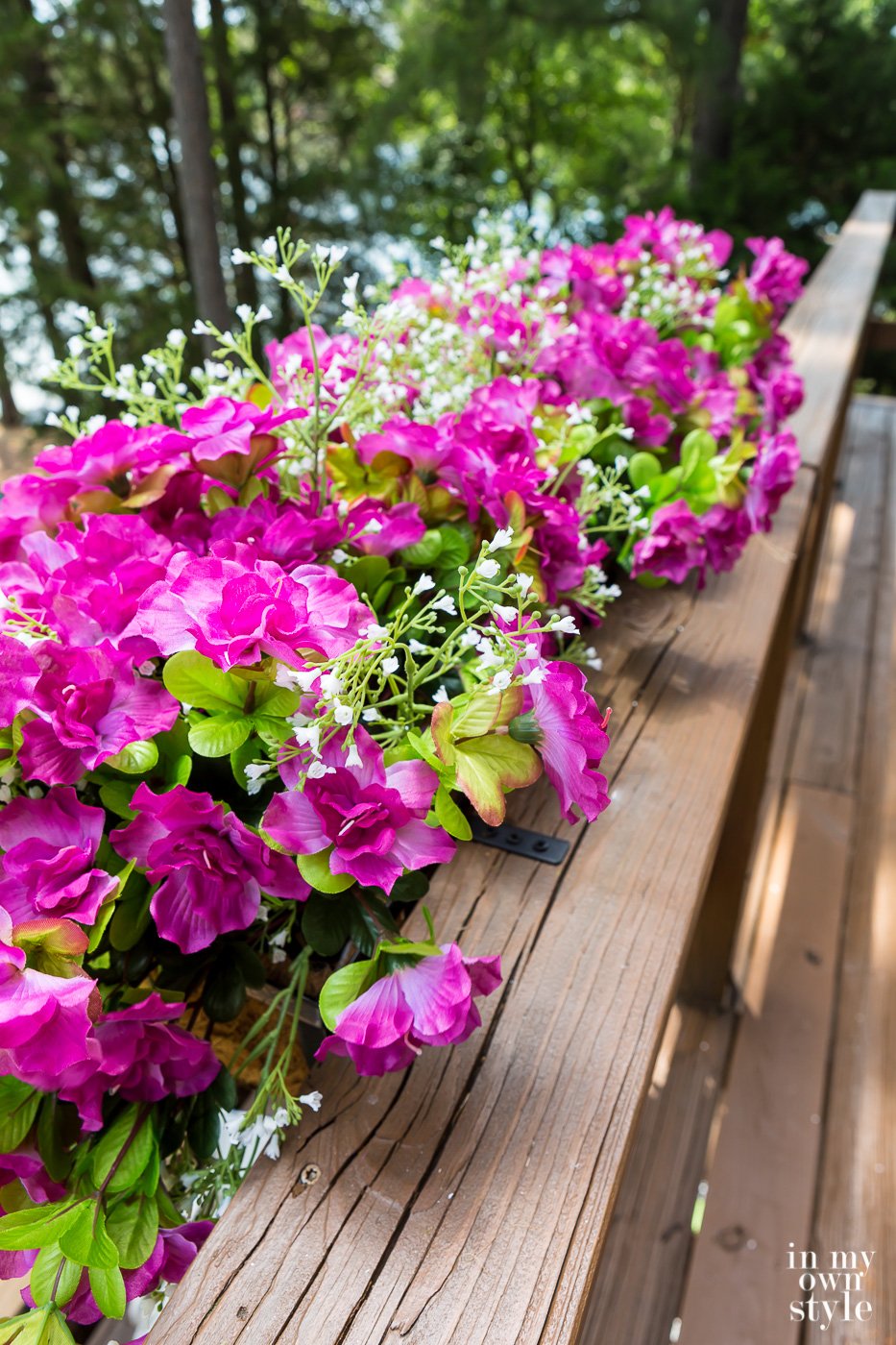 Filling window boxes with artificial flowers.