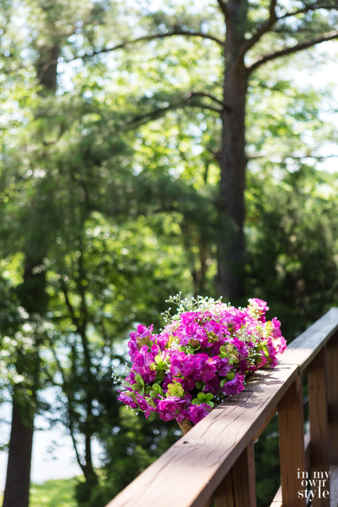 Faux flowers in deck railing planters