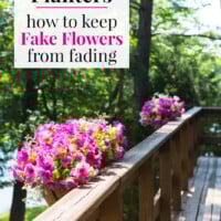 Pink Flower filled deck railing planters along deck. Text overlay says Outdoor Planters how to keep Fake Flowers from fading.