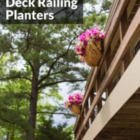 Affordable Deck Railing planters filled with pink flowers hanging from second floor deck railing.
