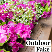 Deck railing flower box filled with fake pink flowers. Text overlay says Outdoor Fake Flower Tips