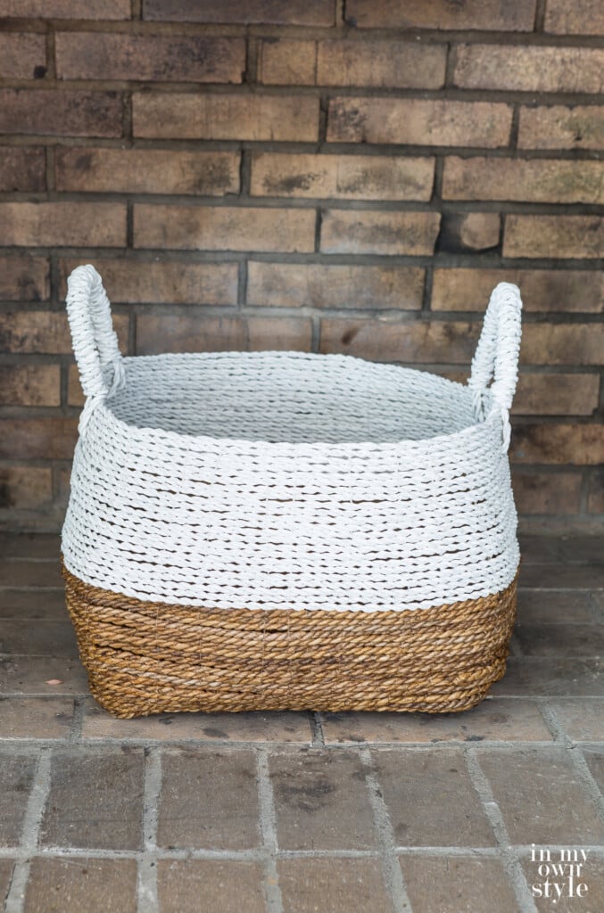 White and natural large basket from Target in empty fireplace