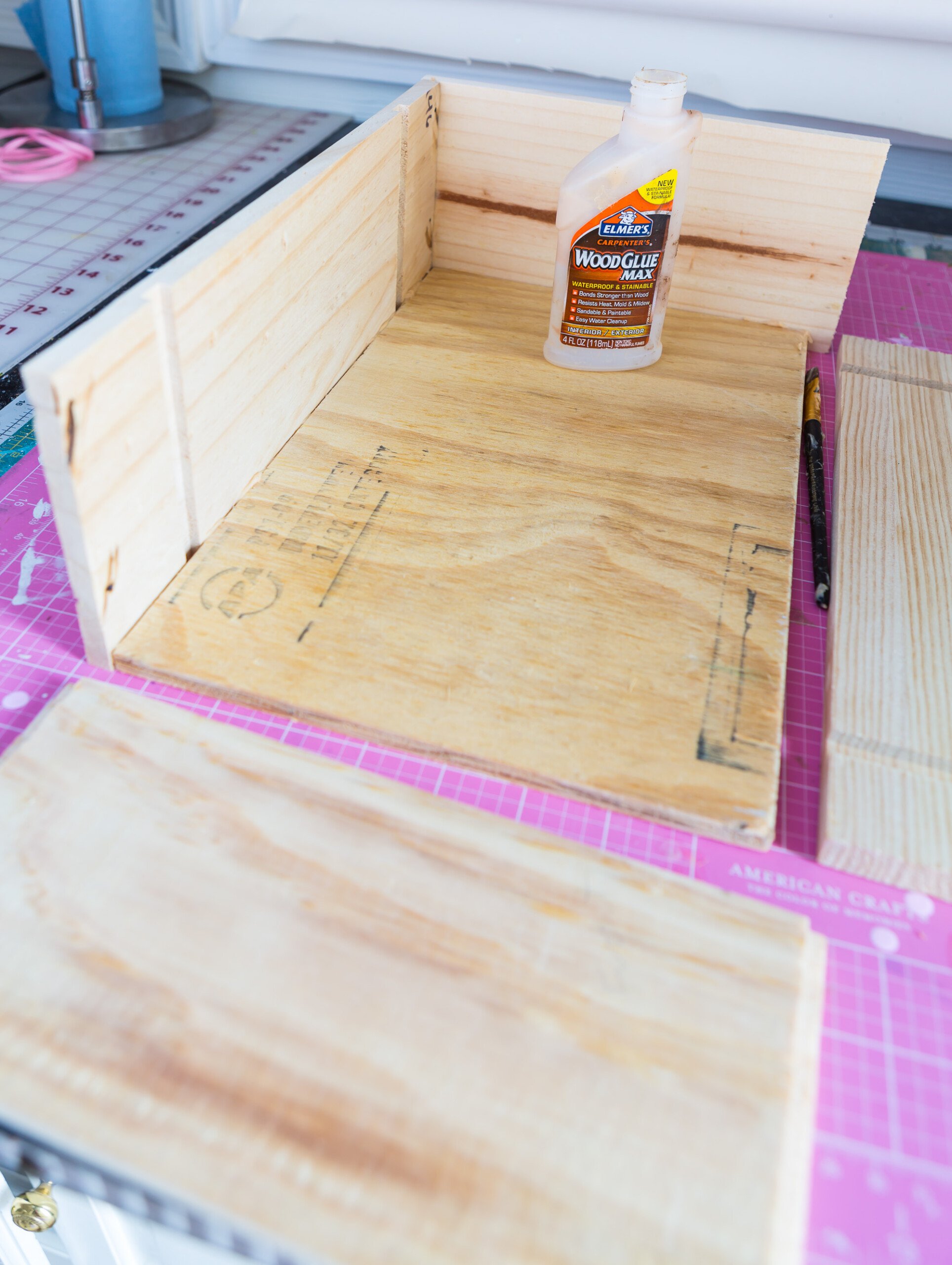 Wood wine panels being glued together to create a box.