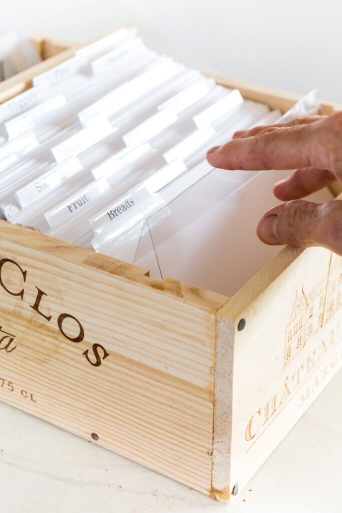 Wine crate fronts repurposed and made into a wood recipe box filled with white index cards and dividers.