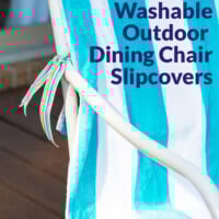 Turquoise and white striped beach towel tied onto an outdoor dining chair as pretty slipcover. Text overlay says how to make no sew washable outdoor dining chair slipcovers.