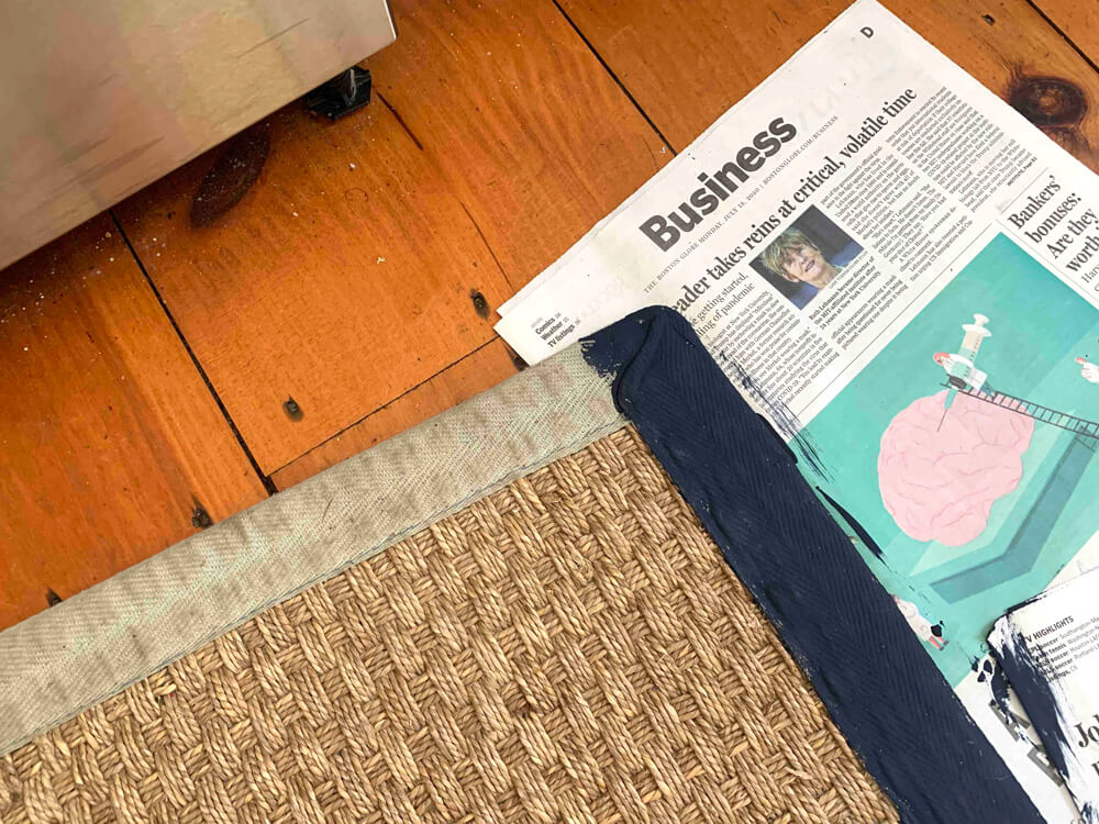 Blog reader sent photo showing how she was inspired by my rug border painting post and started it on her rug using navy paint.