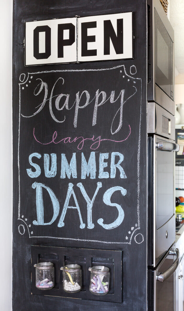Chalkboard wall in kitchen that says Open Happy Lazy Summer Days