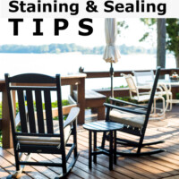 Two black outdoor rockers on lakeside deck. Text overlay says Deck Staining and Sealing Tips