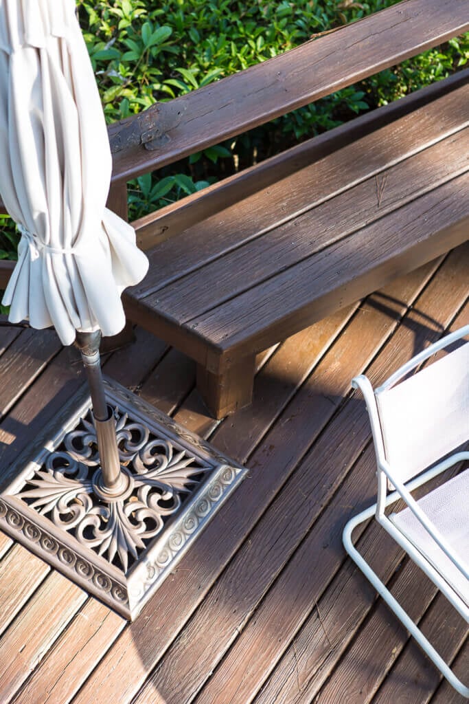 Standing on freshly stained deck looking down into yard and lake.