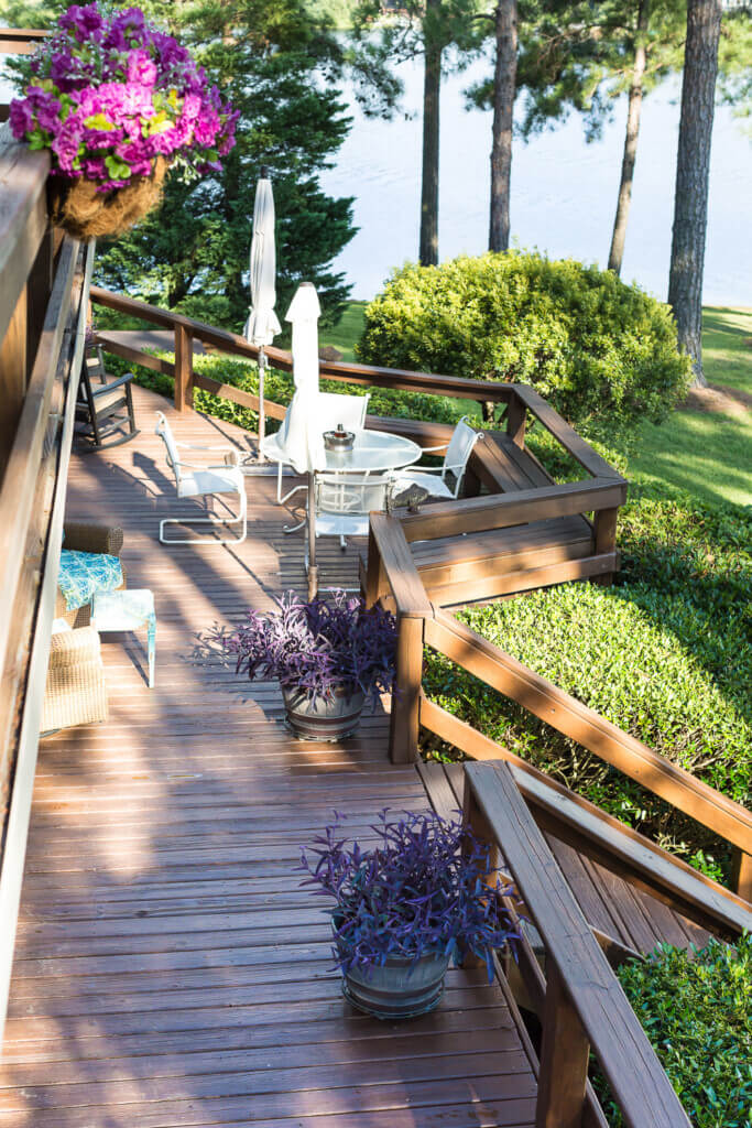 Wood deck after being stained using Behr Semi-Transparent stain in the color Chocolate. View from upper deck to lower deck.