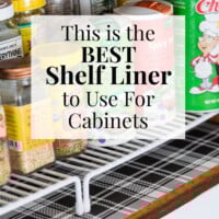 Cut to fit decorative shelf liner paper made using wipeable gift wrap. I used black and white plaid. Text overlay says This is the Best Shelf Liner to Use for Cabinets