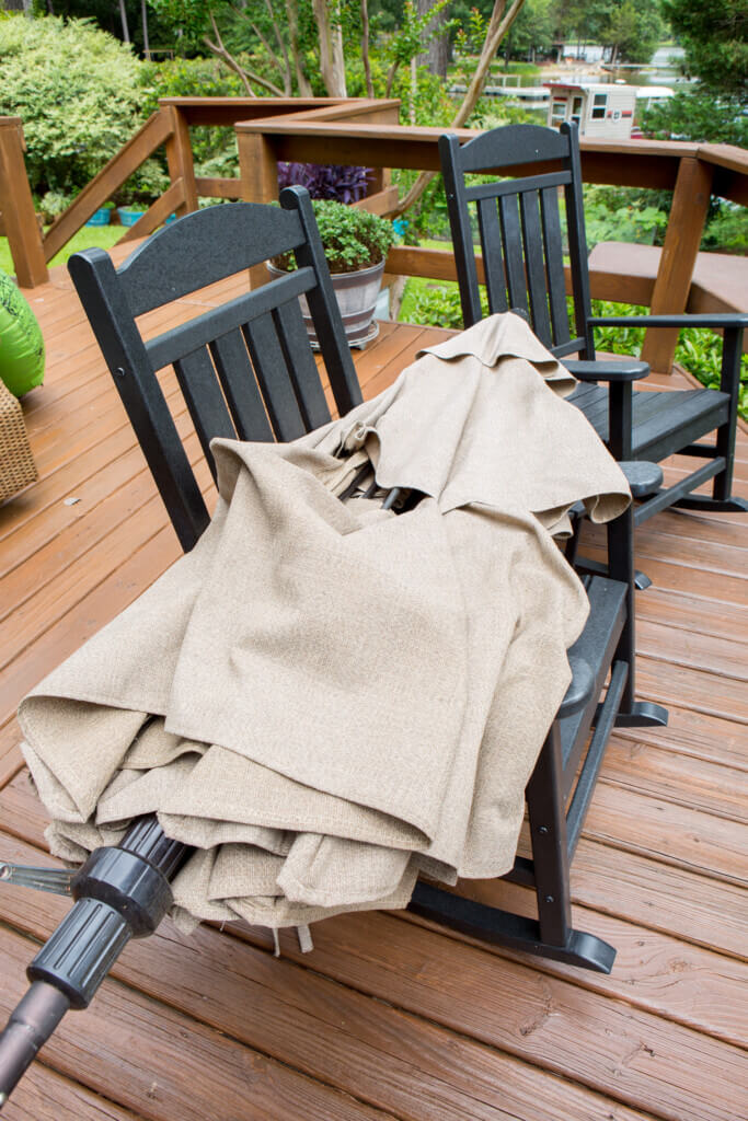 Broken patio umbrella on two deck rocking chairs