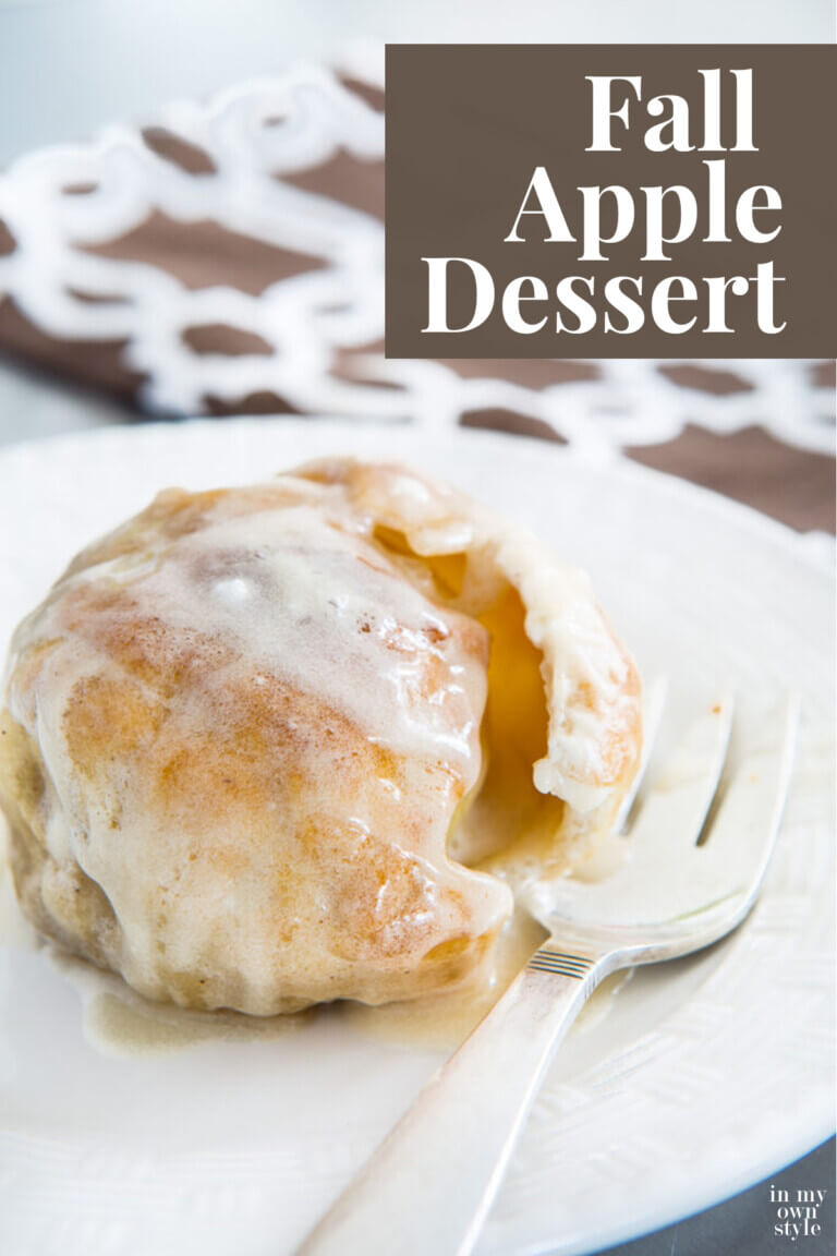 Apple dumpling on plate with fork. Text overlay says Fall Apple Dessert