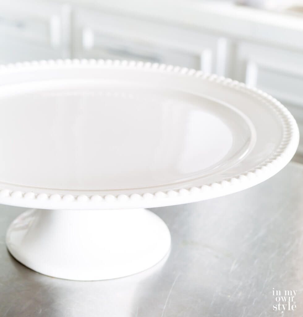 white cake plate with beaded edges can be repurposed for other uses.