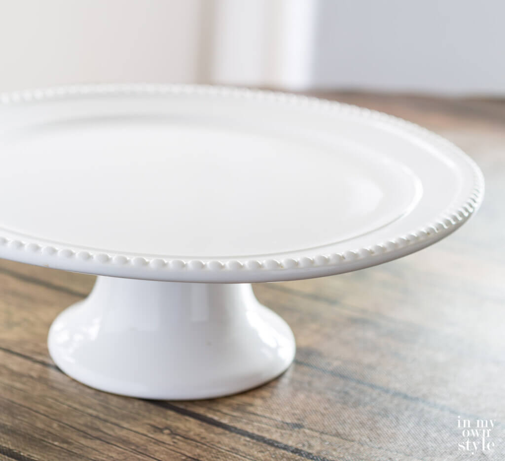 white cake plate with beaded edges can be repurposed for other uses.