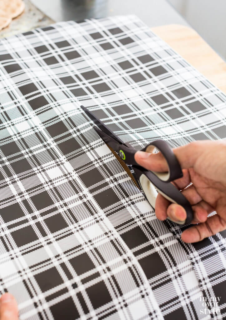 Cutting wipeable gift wrap with scissors.