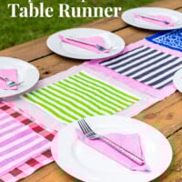 Outdoor picnic table with a colorful table runner in center made with paper napkins.