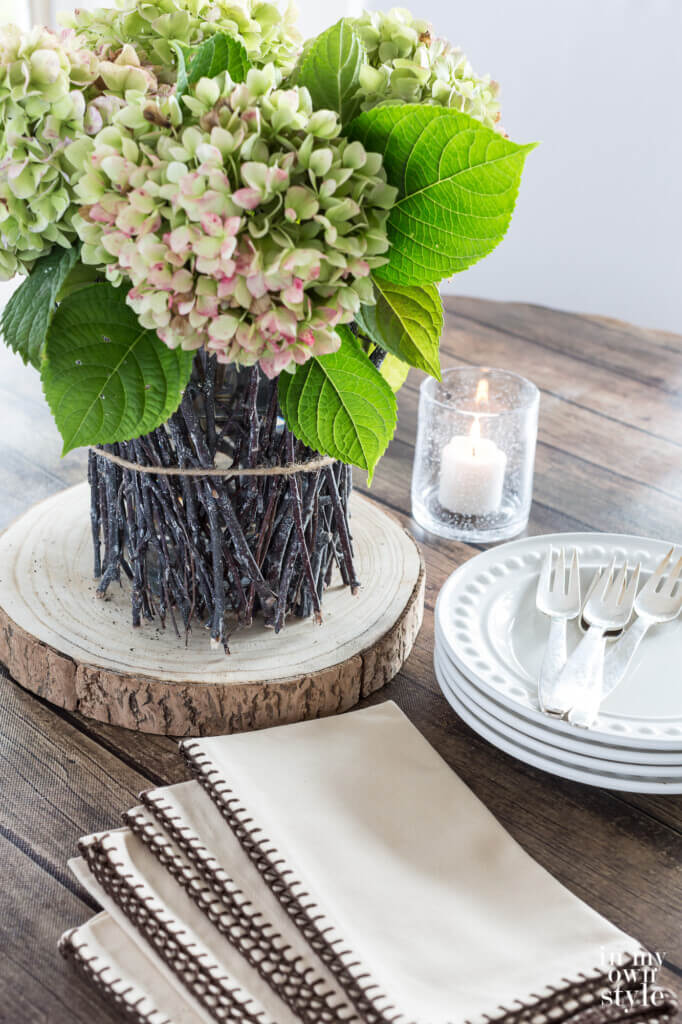Fall dining table centerpiece using twigs and flowers from your yard.
