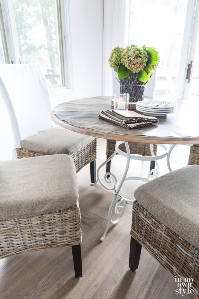 Up close image of new dining chair cushion covers made by repurposing fabric from a broken outdoor umbrella.