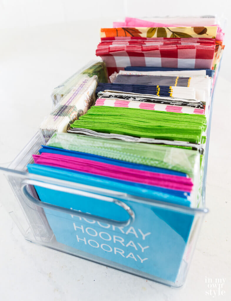 Collection of paper napkins in a long organizing bin.