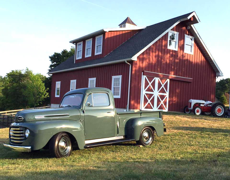 green-vintage-truck-in-front-of-barn