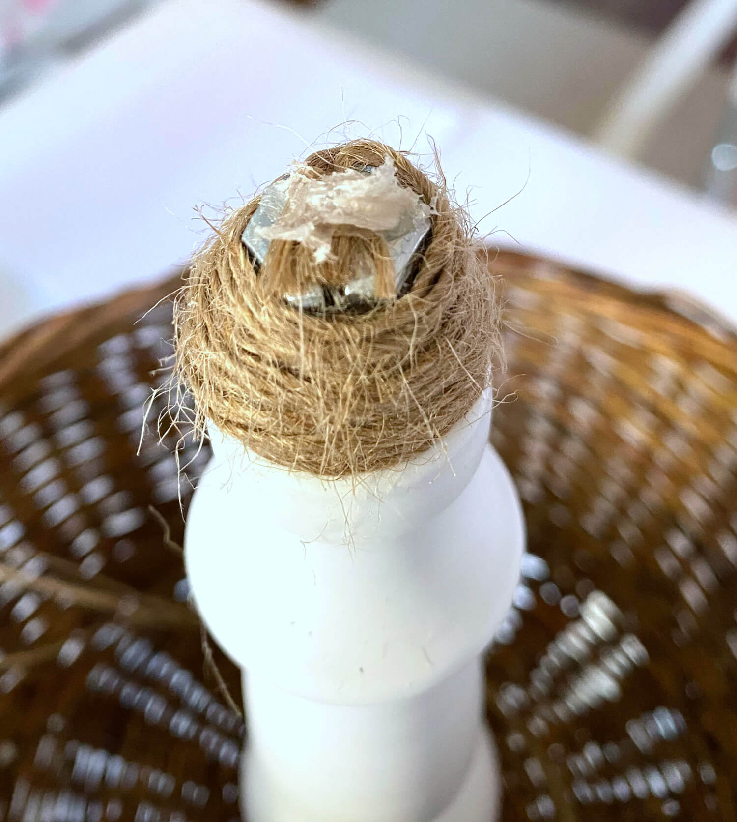 Twine wrapped around top of newly reassembled 2 tier stand with hot glue on top.