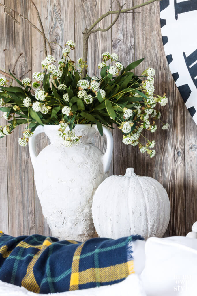 Fall Vase and pumpkin made to look like plaster. Vase filled with white flowers.