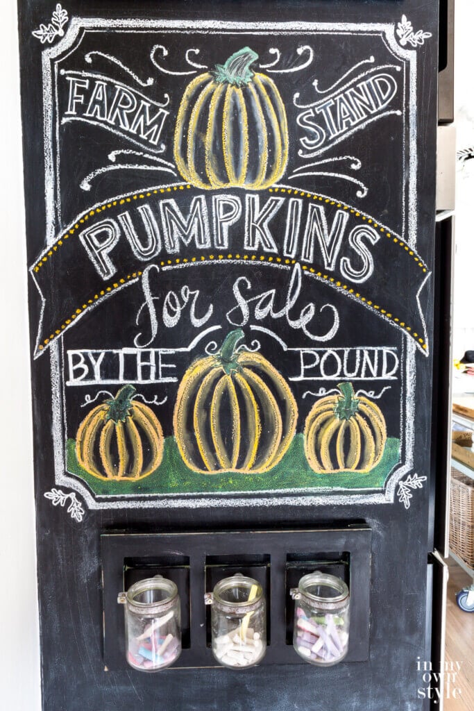 Fall Chalkboard art autumn pumpkins. close up shot of wall that says Farm Stand Pumpkins