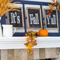 Free Fall Printables It's Fall Y'all on a white mantel with fall decorations around it.