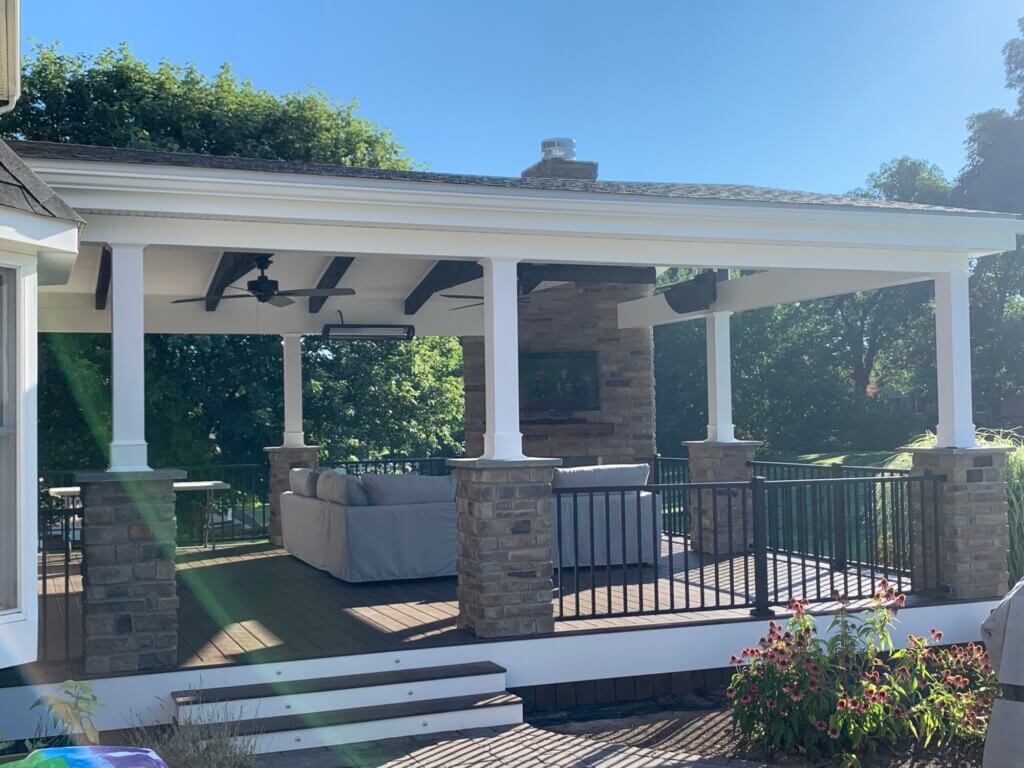 Home addition of a covered porch and fireplace