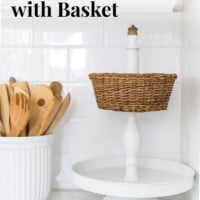 Newly made using parts from other items. White metal 2 tiered stand with a wicker basket and acorn final. text overlay says Make it! 2-Tiered Stand and Wicker Basket