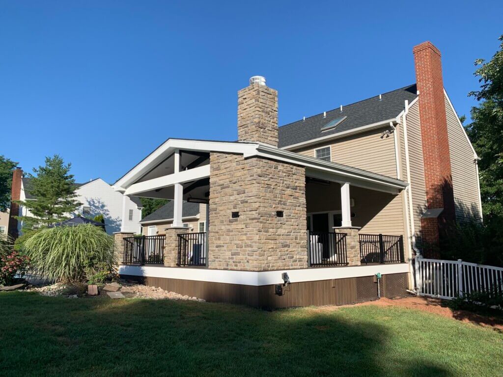 View of new back porch addition to a brick colonial