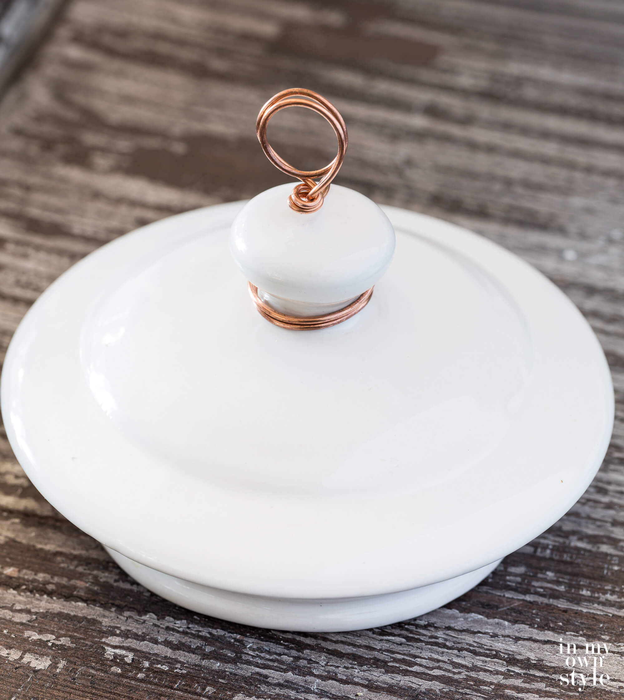 Finished white ceramic teapot lid photo holder without a photo.