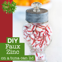 Glass canister jar with a top made using a tuna can painted with a faux Zinc finish. Text overlay says DIY Faux Zinc on a tuna can lid.