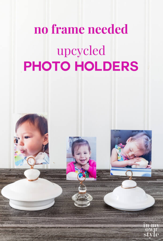 3 teapot lid and jar lid photo holders lined up on a table. Text overlay says no frame needed upcycled photo holders. Creative ways to display photos without frames