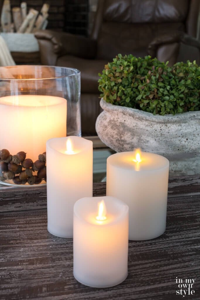 3 fake flicker candles on a coffee table at dusk