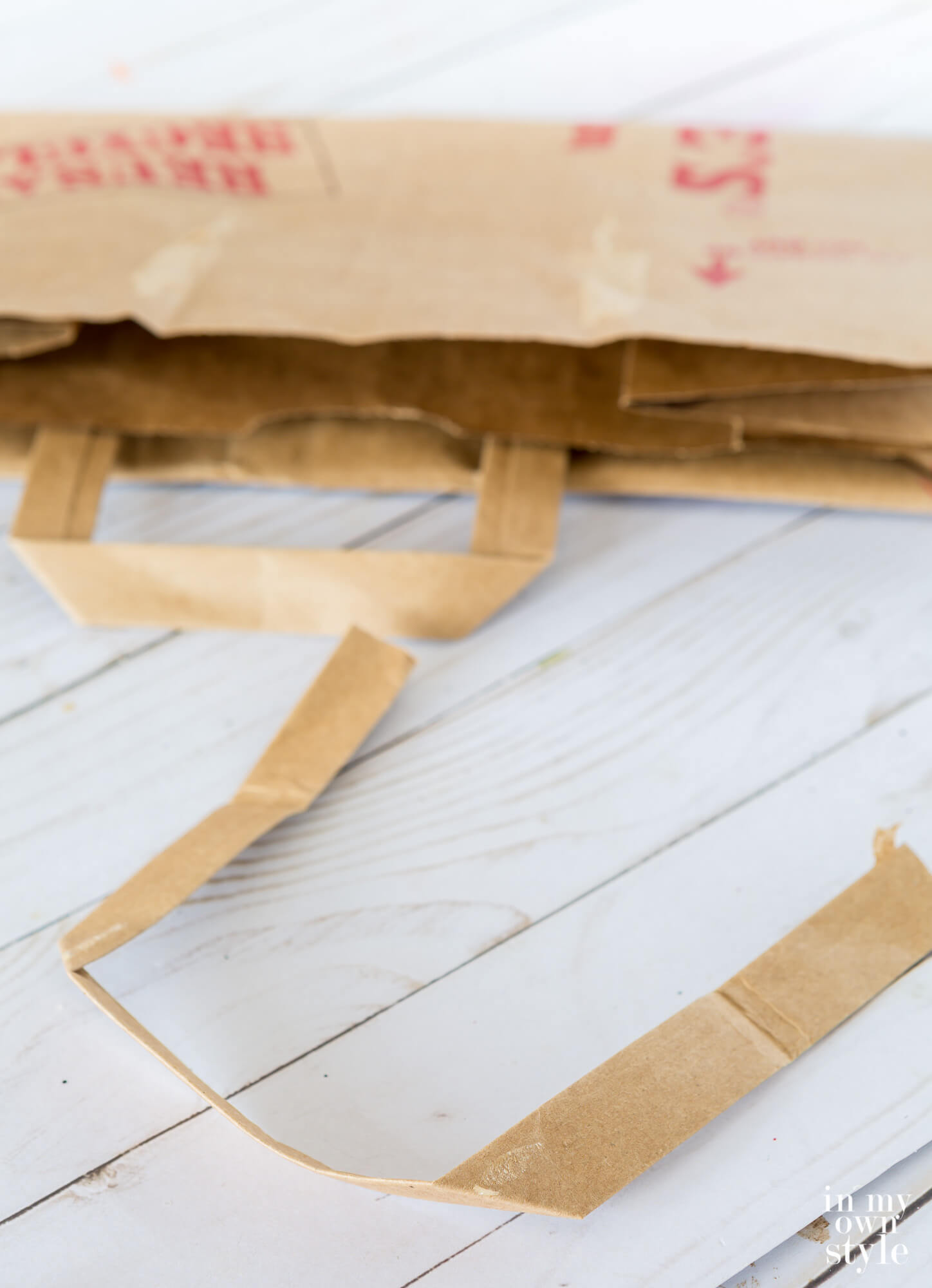 Brown paper bag handle removed from bag.