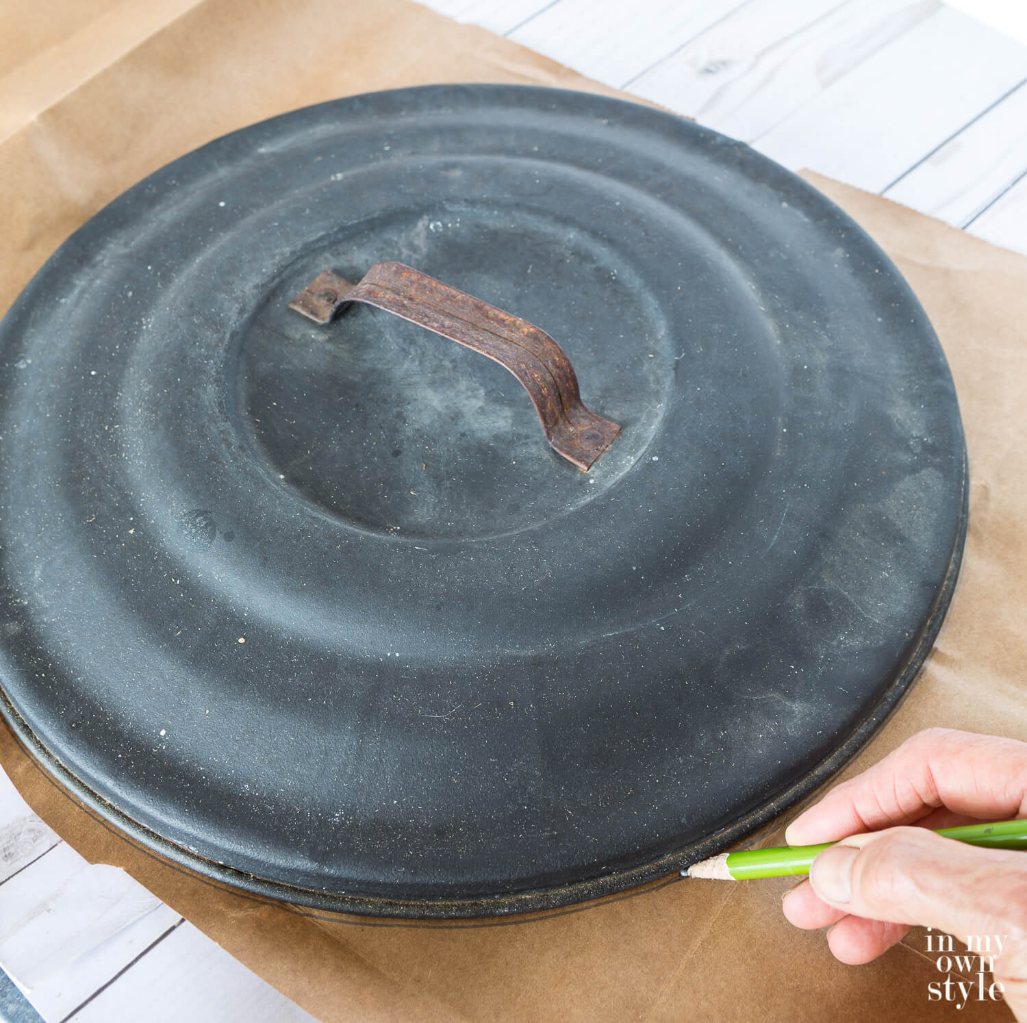 Use a large can lid as template to draw a round circle on an opened brown paper grocery bag.