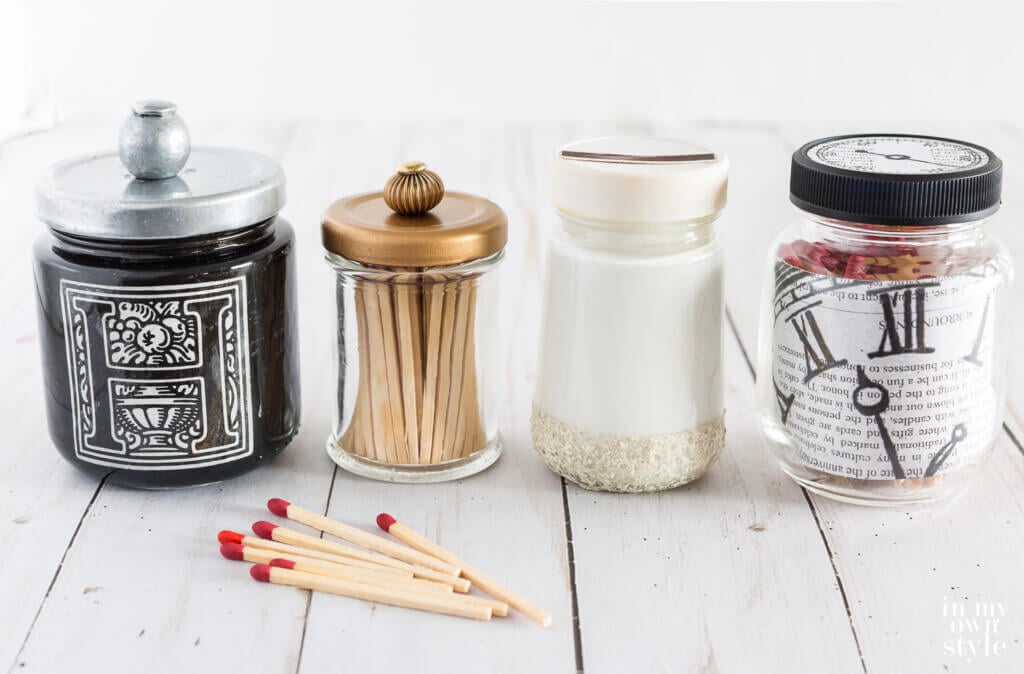 Line up of 4 DIY Match Holders made using small empty glass food jars.