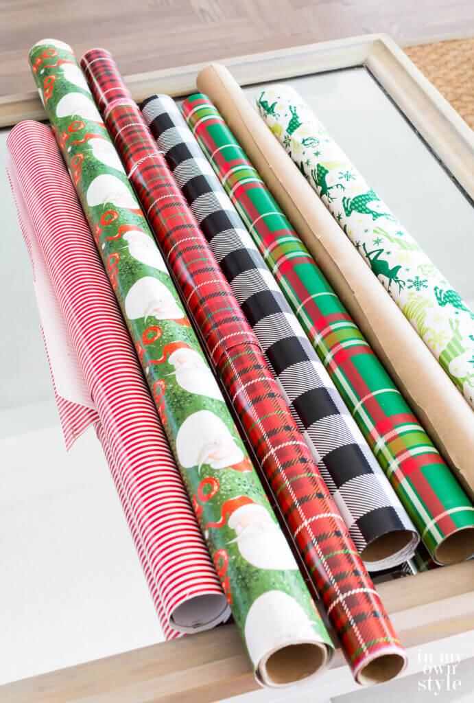 rolls of Christmas gift wrap on a table