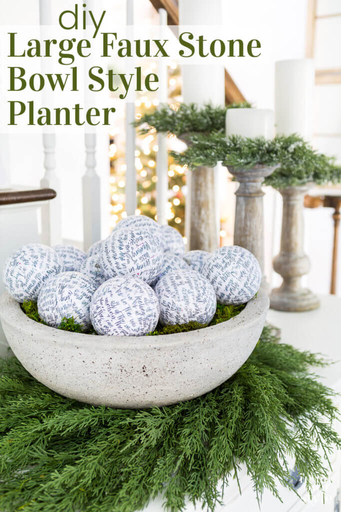 Large faux cement bowl on a wreath on a sideboard. Text overlay says DIY large faux stone bowl style planter.