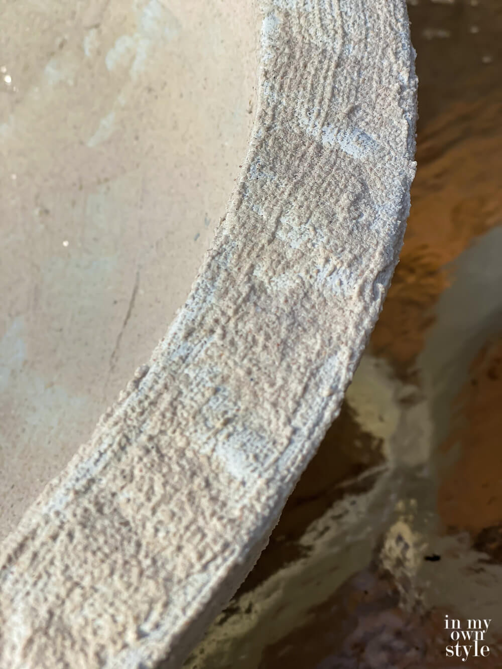 Close up of painted Cobblestone layer of paint on edge of bowl.