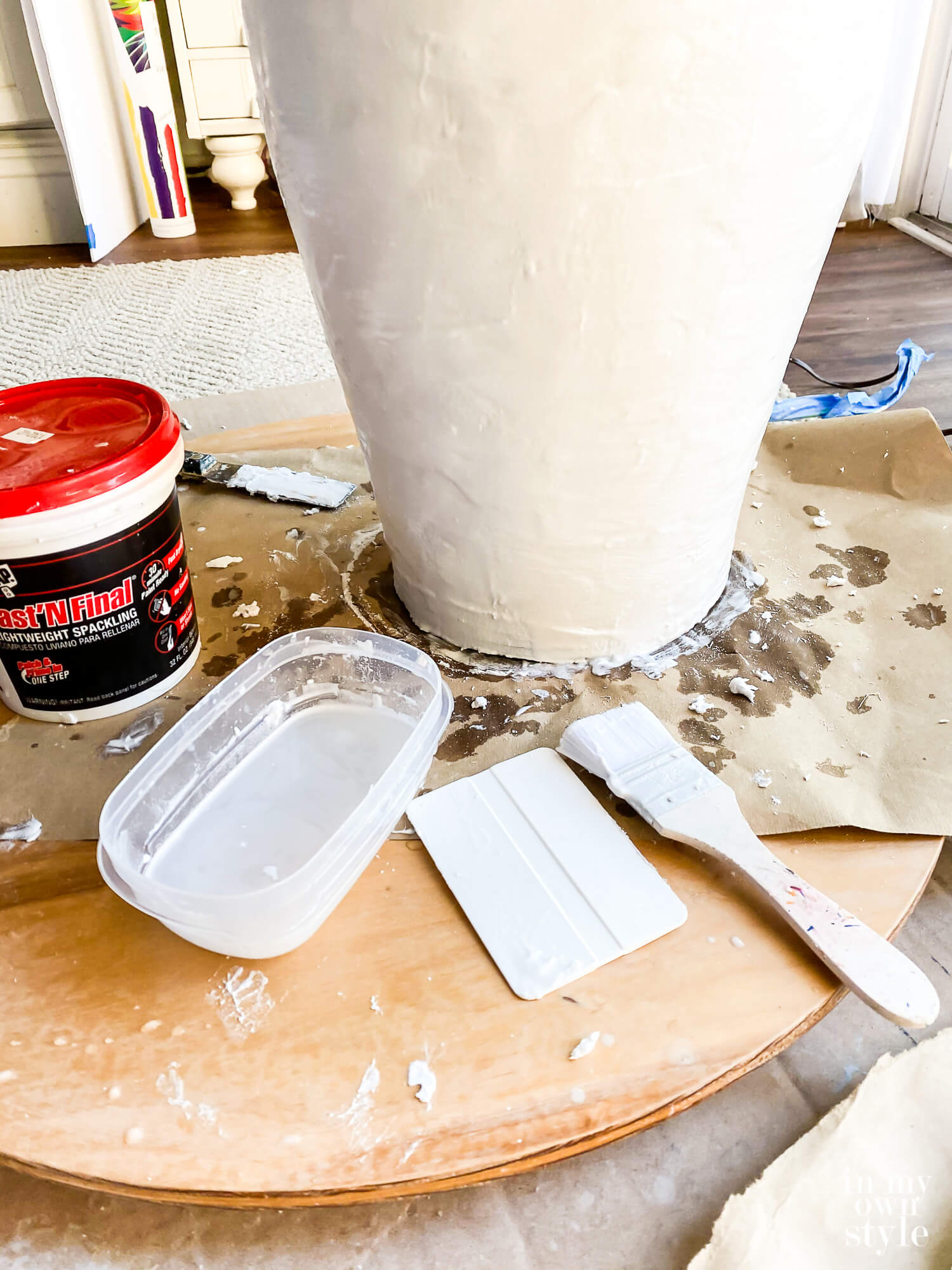 Brush water over Spackle to smooth it on lamp.