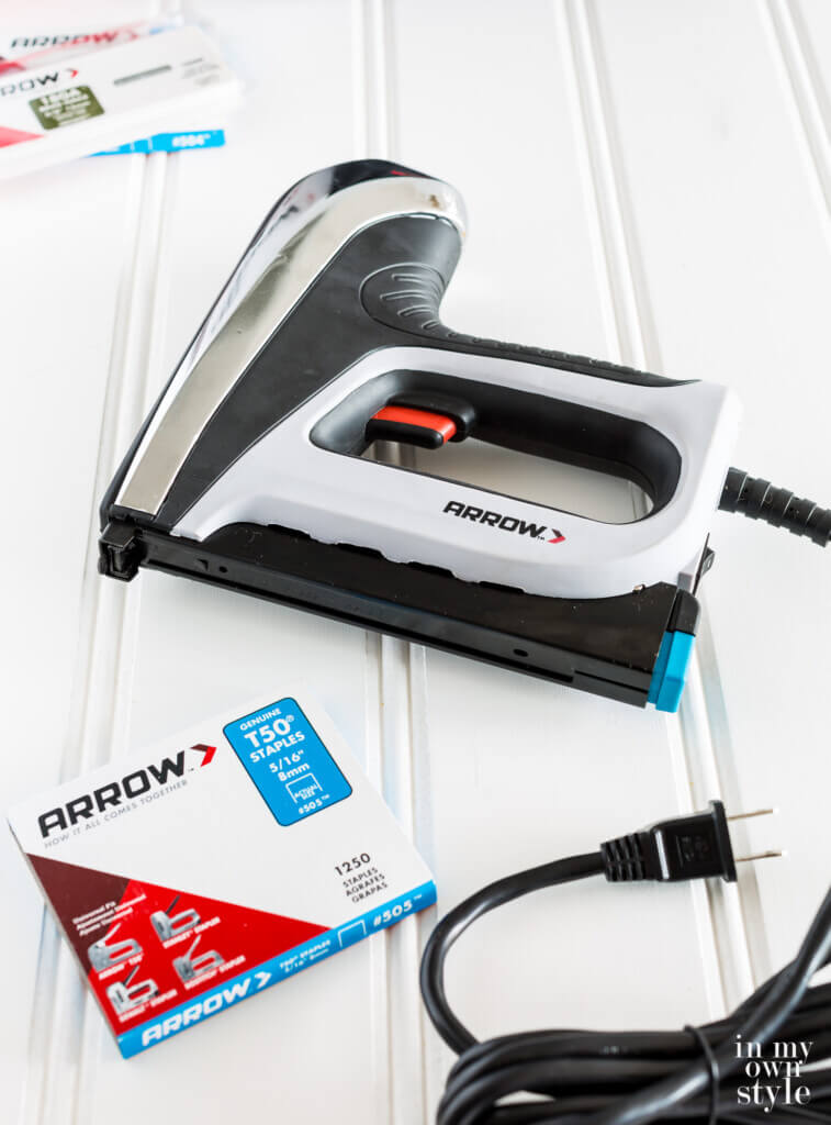 Arrow T50AC on work table along with a box of Arrow staples.